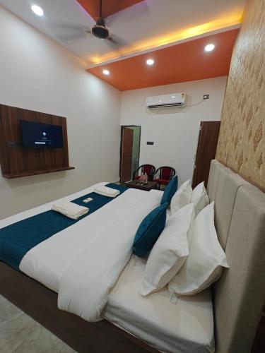 a bedroom with a large bed and a couch at Hotel The R L Palace - "A Luxurious Hotel" 900 Meters From Ram Mandir Ayodhya in Ayodhya