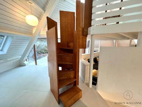 a staircase in a house with wooden stairs at Le Tipi - Sauna et Jardin in Esneux