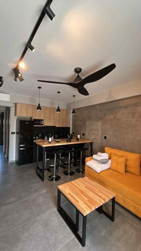 a living room with a couch and a table at Old Cinema Suites - Stylishly Decorated Retreat with Pool or Jacuzzi by the Sea in the Heart of Laganas Βy Villa Mana Gers in Laganas