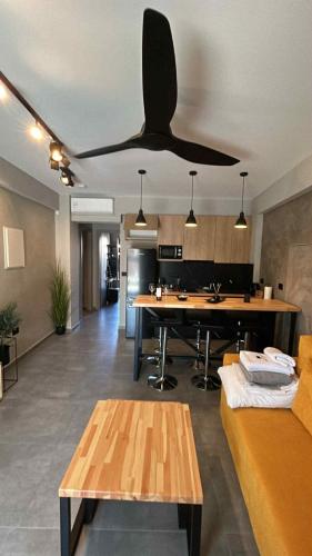 a large living room with a ceiling fan at Old Cinema Suites - Stylishly Decorated Retreat with Pool or Jacuzzi by the Sea in the Heart of Laganas Βy Villa Mana Gers in Laganas