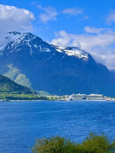 a large body of water with a mountain in the background at Bispen Villa Utsikten in Åndalsnes