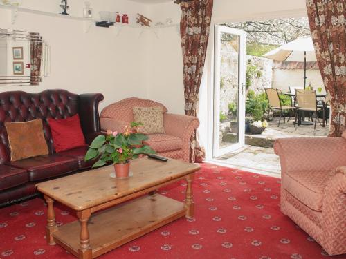 a living room with a couch and a coffee table at Churchview House in Winterborne Abbas
