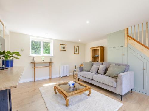 a living room with a couch and a table at South Wood Lodge in Slindon