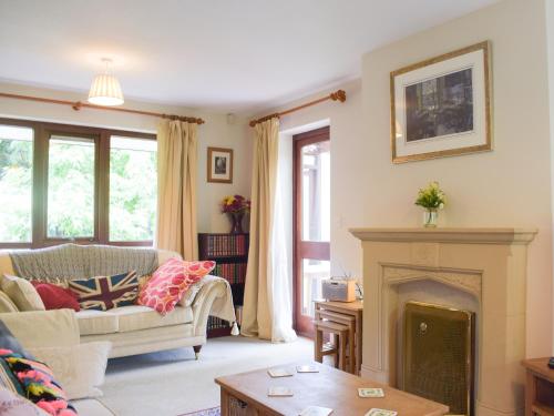 a living room with a couch and a fireplace at Kuliguni in Ross on Wye