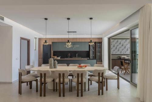 a kitchen and dining room with a table and chairs at Luxurious Villa Selestine - With Private Pool in Panormos Rethymno
