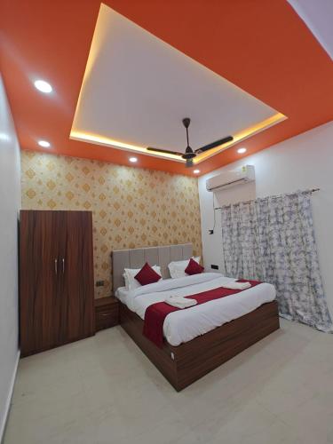 a bedroom with a large bed in a room at Hotel The R L Palace - "A Luxurious Hotel" 900 Meters From Ram Mandir Ayodhya in Ayodhya