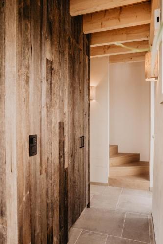 a wooden wall in a room with a staircase at Les hauts de Somme-Lodge Durbuy in Somme-Leuze