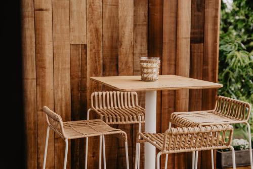 a table and two chairs and a table with a cup on it at Les hauts de Somme-Lodge Durbuy in Somme-Leuze