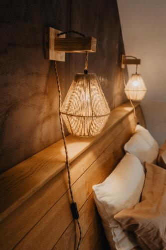 a room with a bed and a hanging lamp at Les hauts de Somme-Lodge Durbuy in Somme-Leuze