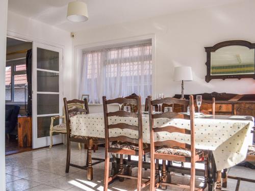 a dining room with a table and chairs at Botany Bay Bungalow in Kingsgate