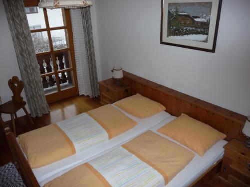 a bedroom with two beds and a window at Landhaus Fiausch in Mallnitz