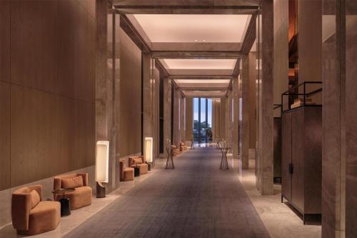 a hallway with couches and chairs in a building at Conrad Shenzhen, the first art museum hotel in Greater Bay Area with the stunning bay and sunset view in the hotel terrace in Shenzhen