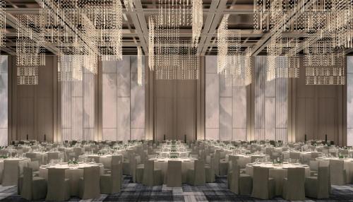 a banquet hall with white tables and white chandeliers at Conrad Shenzhen, the first art museum hotel in Greater Bay Area with the stunning bay and sunset view in the hotel terrace in Shenzhen
