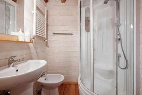 a white bathroom with a sink and a shower at Le Fratte in Pertica Alta