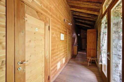 a hallway of a wooden house with a door at Le Fratte in Pertica Alta
