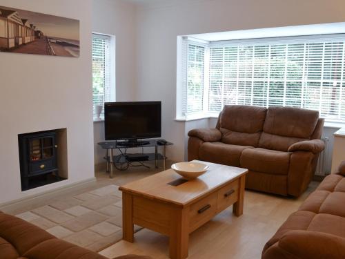a living room with a couch and a tv at Oakwood in Bridlington