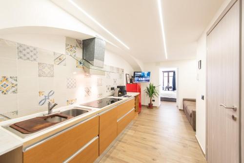 a kitchen with two sinks and a couch at the Heart of Turin Center in Turin