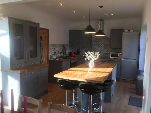 a kitchen with a wooden table and some chairs at Huge 6 Bedroom House in Sheringham in Sheringham
