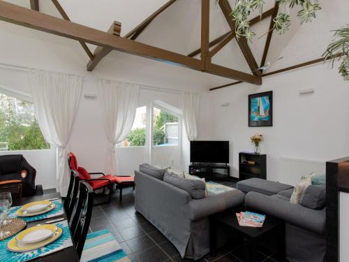 a living room with a couch and a table at The Boathouse in East Cowes