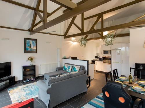 a living room with a couch and a table at The Boathouse in East Cowes