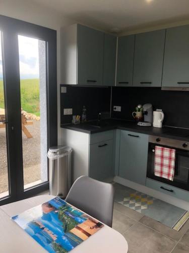 Una cocina con una mesa y una silla en una habitación. en Location appartement T2 - 1 chambre le bourget du lac, en Le Bourget-du-Lac