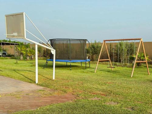 a basketball hoop and a net in a park at Peaceful Family Villa on a Farm with Private Pool and Stunning Mountain Views in Agadir