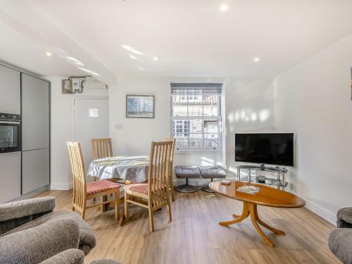 a living room with a bed and a table and a couch at Two Little Ducks in Wells next the Sea