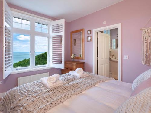 a bedroom with a bed with two towels on it at Haven Heights in Martinhoe