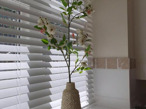 a vase with flowers in it in a window at Haven Heights in Martinhoe