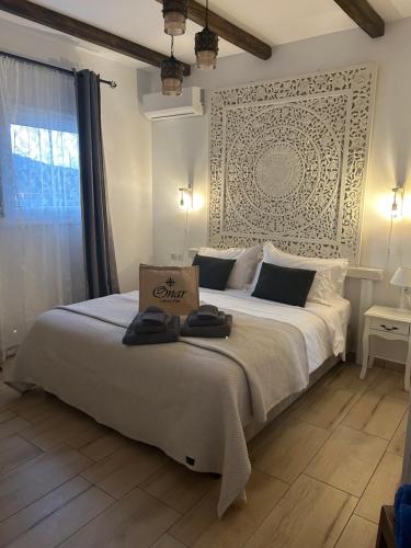 a bedroom with a large bed with a box on it at Onar Luxury Villa - Adults Only in Lachania