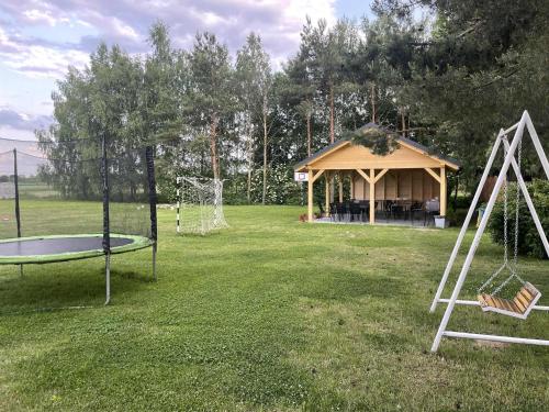 a gazebo with a trampoline and a trampoline at Noclegi u Eli Zator Energylandia in Zator