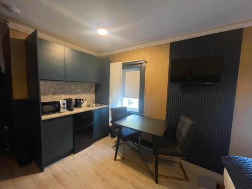 a small kitchen with a table and a microwave at First Floor Studio in Dublin
