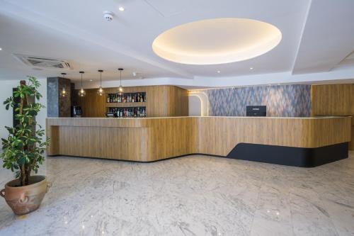 a lobby of a hotel with a bar at Xemxija Bay Hotel in St Paul's Bay