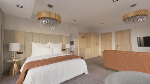 a bedroom with a large bed and two chandeliers at Prestige Hotel in Stalowa Wola