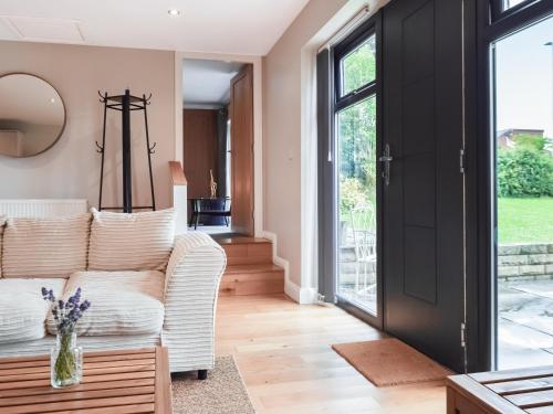 a living room with a couch and a table at The Farmhouse Retreat in Millbrook