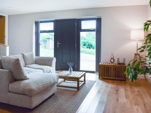 a living room with a couch and a coffee table at The Farmhouse Retreat in Millbrook