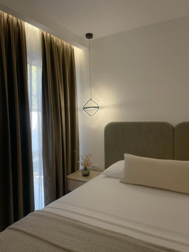 a bedroom with a white bed and a window at Casa Nita in Ulcinj