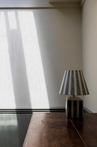 a small lamp sitting on a table in a room at The London & Paris Hotel in Folkestone