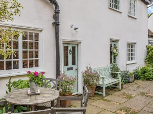 a patio with a table and chairs in front of a house at Uk44005 - Carters Yard in Kimbolton
