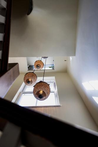 three lights hanging from the ceiling of a room at The London & Paris Hotel in Folkestone