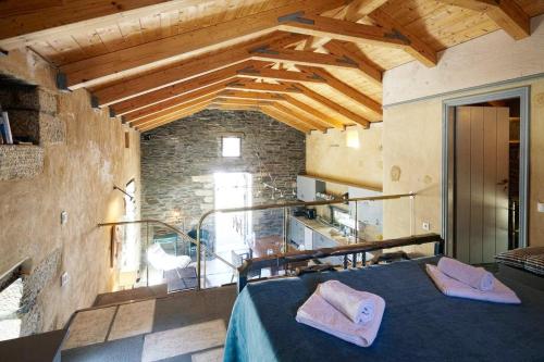 a room with a bed and a stone wall at Tinos island-Secluded beach house retreat 'VATHI' in Tinos Town