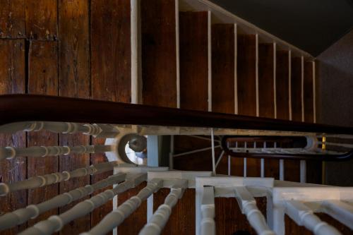 a staircase in a room with wooden walls at The London & Paris Hotel in Folkestone