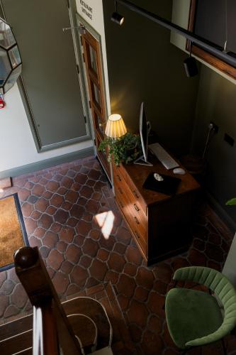a room with a desk with a lamp and a chair at The London & Paris Hotel in Folkestone