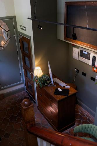an office with a desk with a lamp on it at The London & Paris Hotel in Folkestone