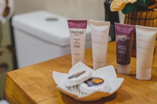 a group of four products sitting on a table at Pousada Ho'oponopono Chalets & Wine in Sapucaí-Mirim