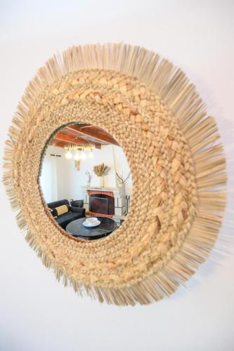 a mirror hanging on a wall with a living room at Azure Horizon Skyros in Skiros