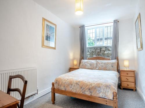 a bedroom with a bed and a table and a window at Bengough's Annexe in Berkeley