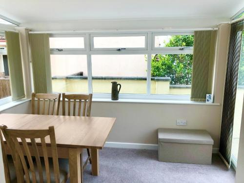a dining room with a table and a window at Harry's in Torquay
