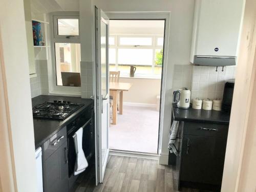 a kitchen with a sink and a stove top oven at Harry's in Torquay