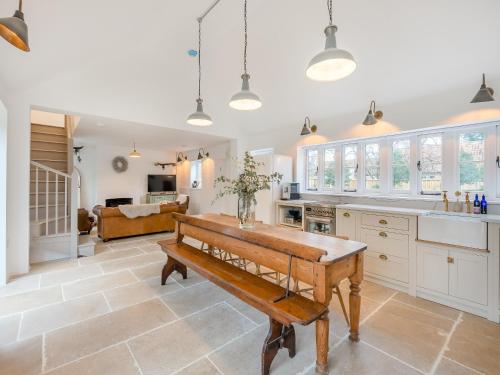a kitchen with a bench in the middle of a room at The Ostlers Cottage in Sleaford